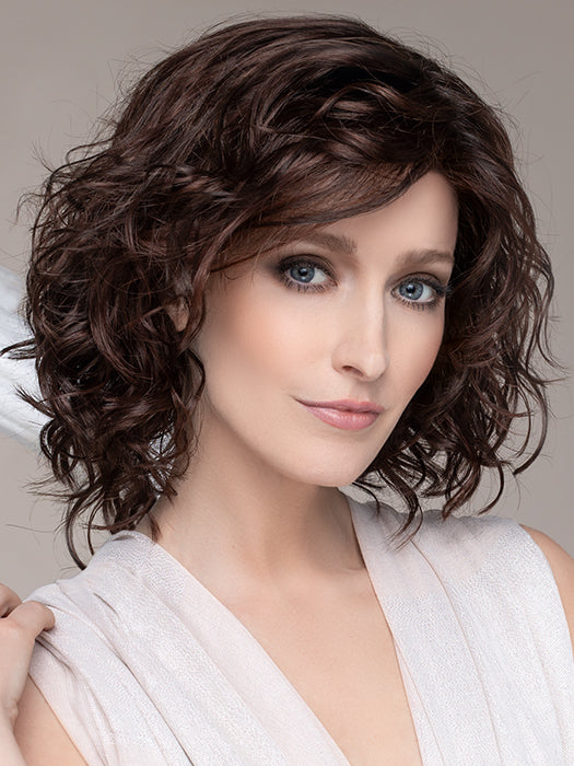 DELICATE PLUS by ELLEN WILLE in DARK CHOCOLATE MIX   This image was styled as follows: Curling iron 350°F with a ¾” barrel size, alternating curling directions. Finished by lightly scrunching hair with a small amount of BeautiMark Velvet Spray Gel 